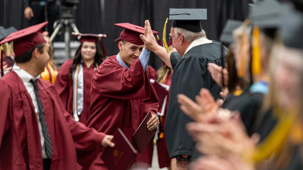 Graduate giving a high five