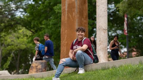 Gateway to College student sitting in courtyard on the Pueblo Campus