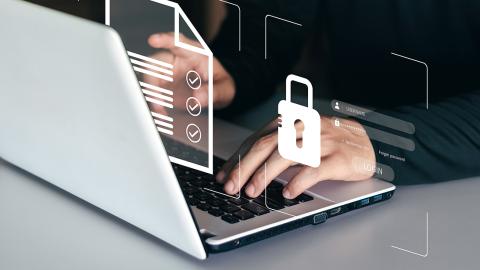 Hands at computer with padlock graphic
