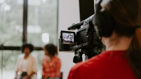 an interview being viewed from behind a video camera