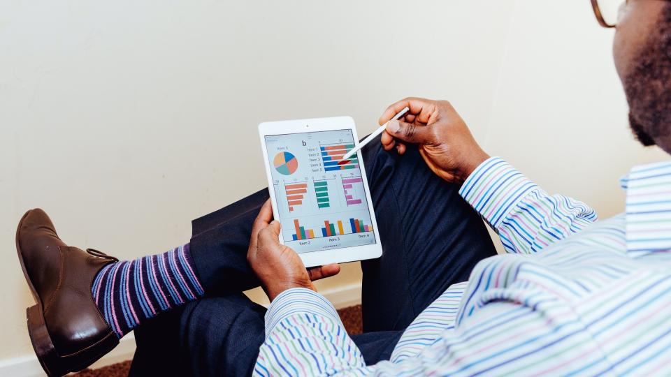 Nice dressed man looking at a tablet