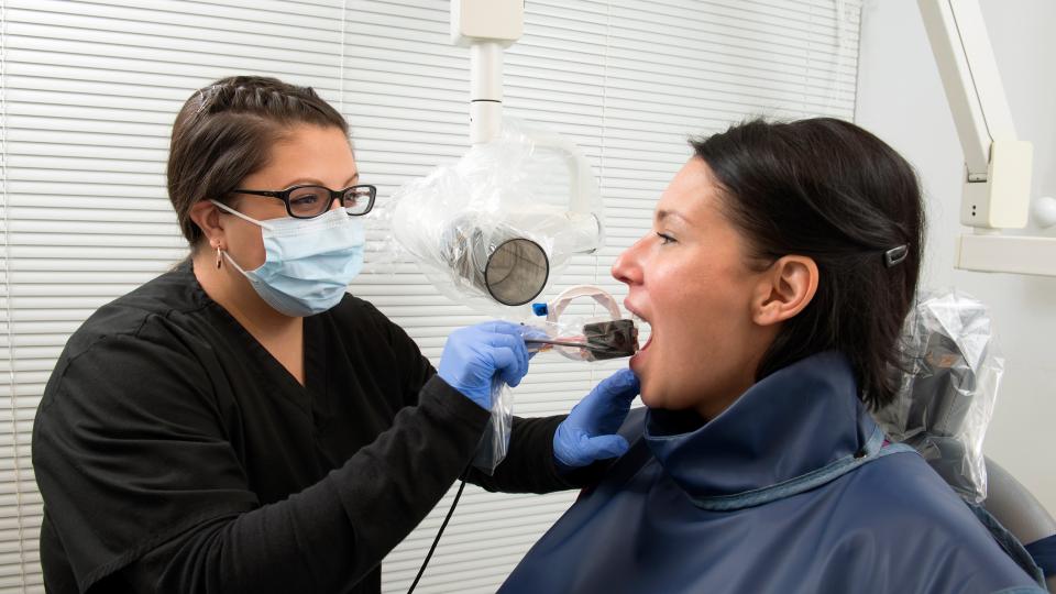 Dental Hygiene student performing an exam