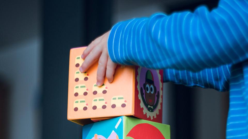 child stacking blocks