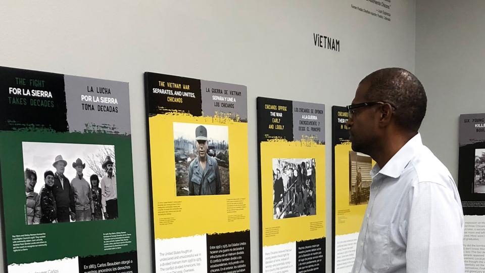 Visitor looking at items in the El Movimiento Exhibit