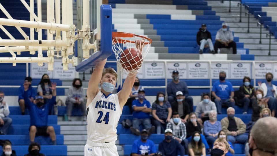 Kyle Bigley dunking basketball for Central High School