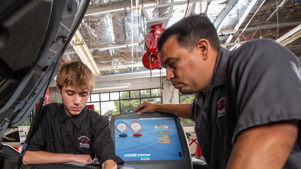 James Cordova with student in PCC's auto body shop