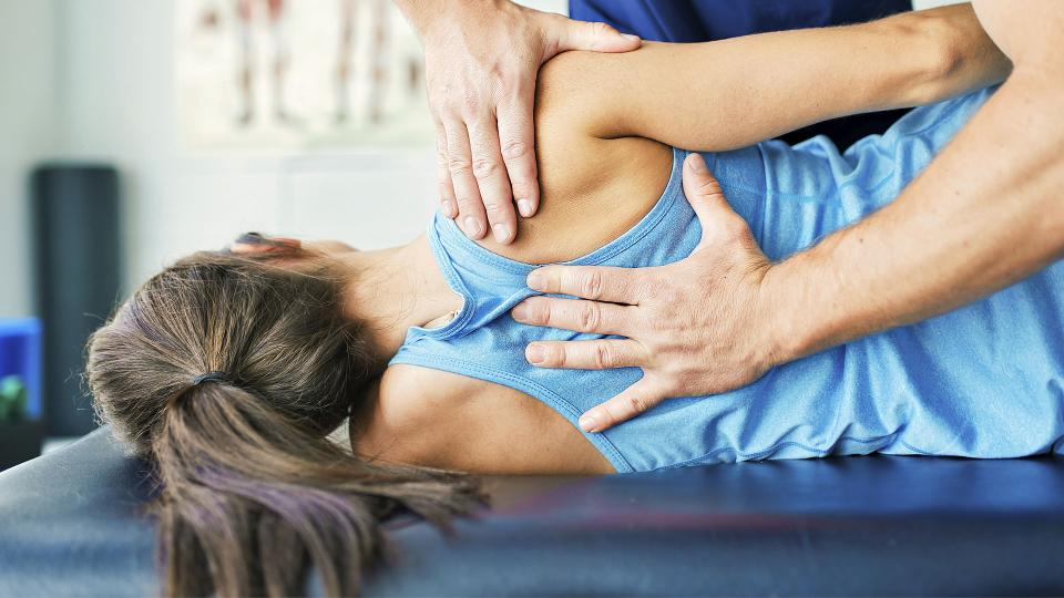 Physical Therapist working on a woman's back