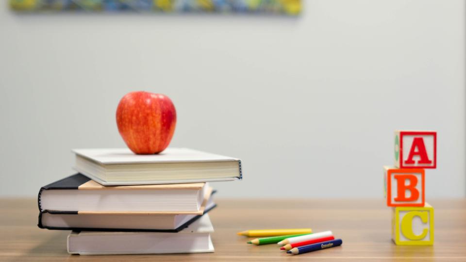 Desk with book and an apple