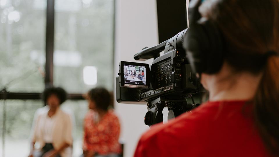 an interview being viewed from behind a video camera