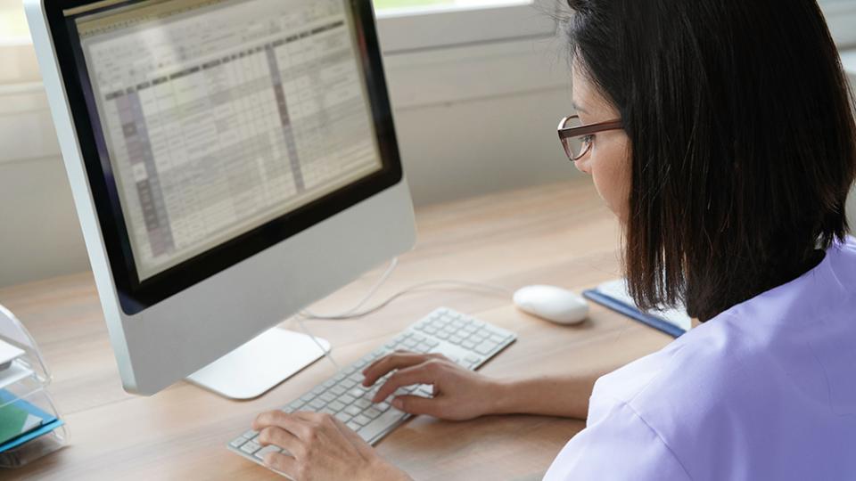 Medical Coding card - woman at computer