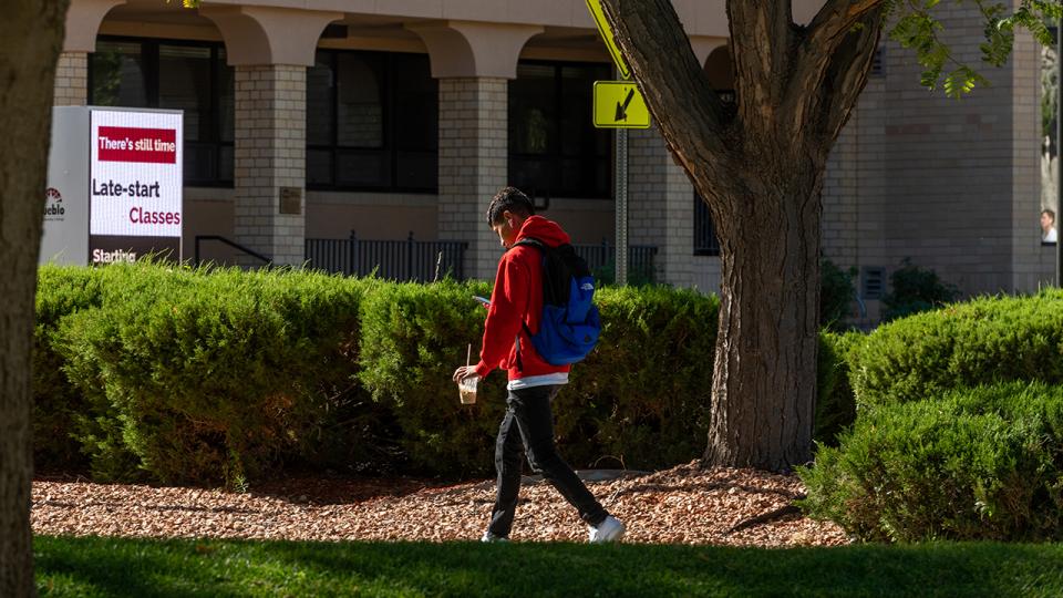 Student walking across Pueblo campus
