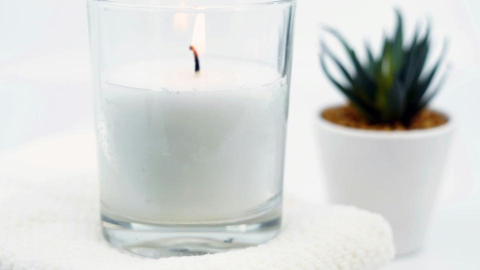 candle, towel, and plant
