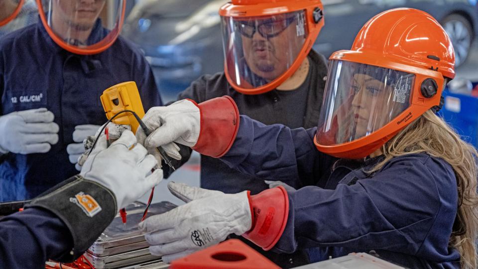 Lucy Amorette, right, tests a battery cell with fellow students, Will Rivas, center, and Christopher Mondragon, far left, at Pueblo Community College Electric Vehicle service class in Pueblo on Thursday, February 19, 2026. (The Gazette, Michael G. Seamans)