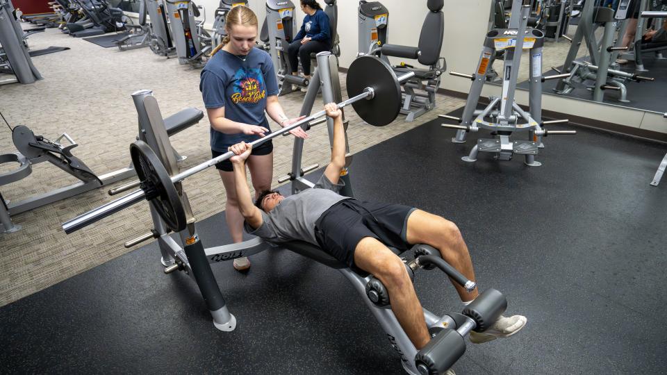 students lifting weights in the PCC Rec Center