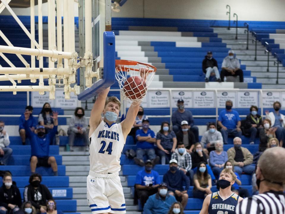 Kyle Bigley dunking basketball for Central High School