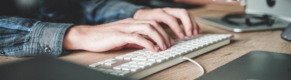 hands typing on keyboard