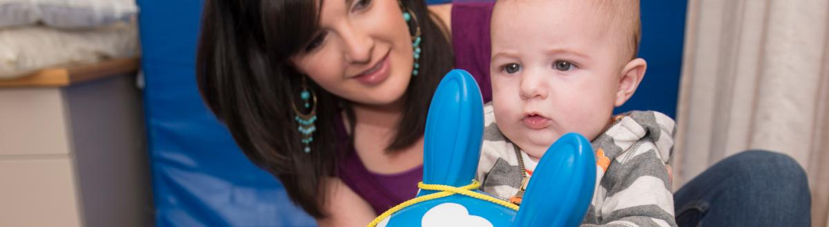 Baby on inflatable horse during therapy session