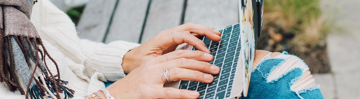 student outside on laptop