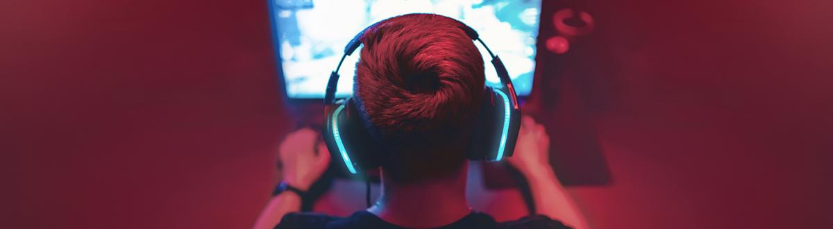 view from behind of a gamer with headset on