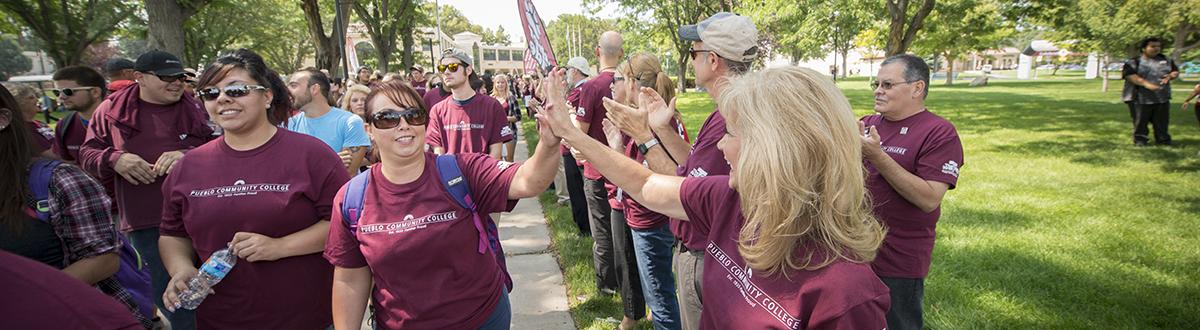 President Erjavec high fives students during Celebration Walk