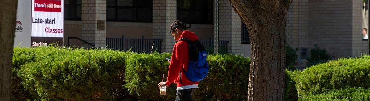 Student walking across Pueblo campus