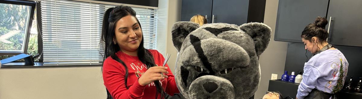 PCC Panther getting a haircut in the Cosmetology Clinic