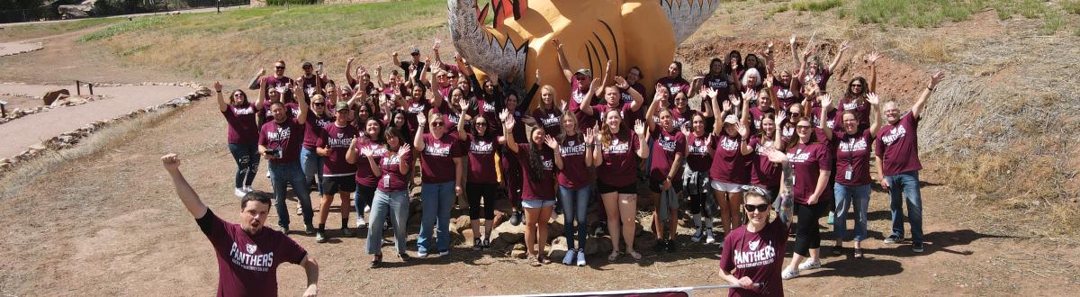 Fremont Campus Celebration Walk - Group in front of dinosaur