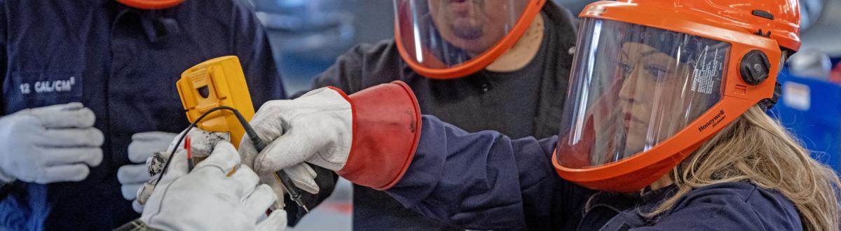 Lucy Amorette, right, tests a battery cell with fellow students, Will Rivas, center, and Christopher Mondragon, far left, at Pueblo Community College Electric Vehicle service class in Pueblo on Thursday, February 19, 2026. (The Gazette, Michael G. Seamans)