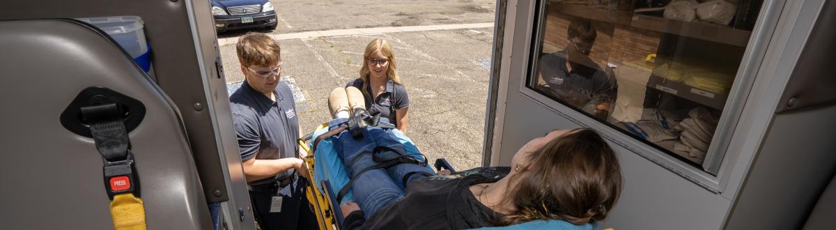 PCC EMT students loading patient into ambulance