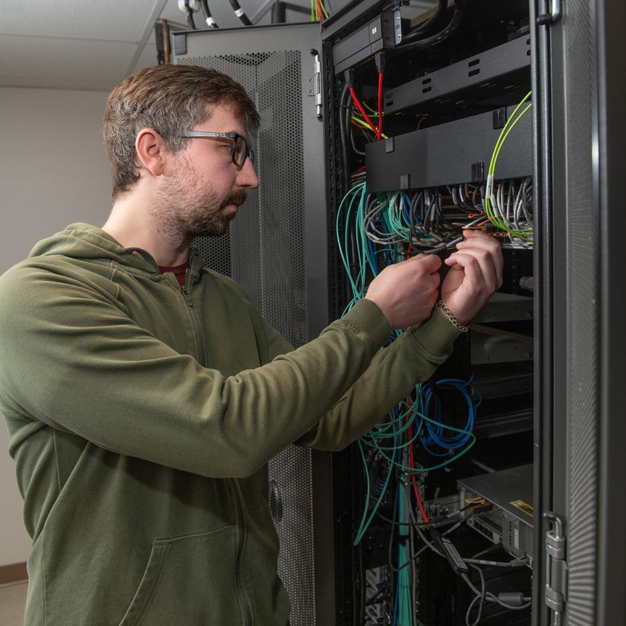 Male CIS student working on server