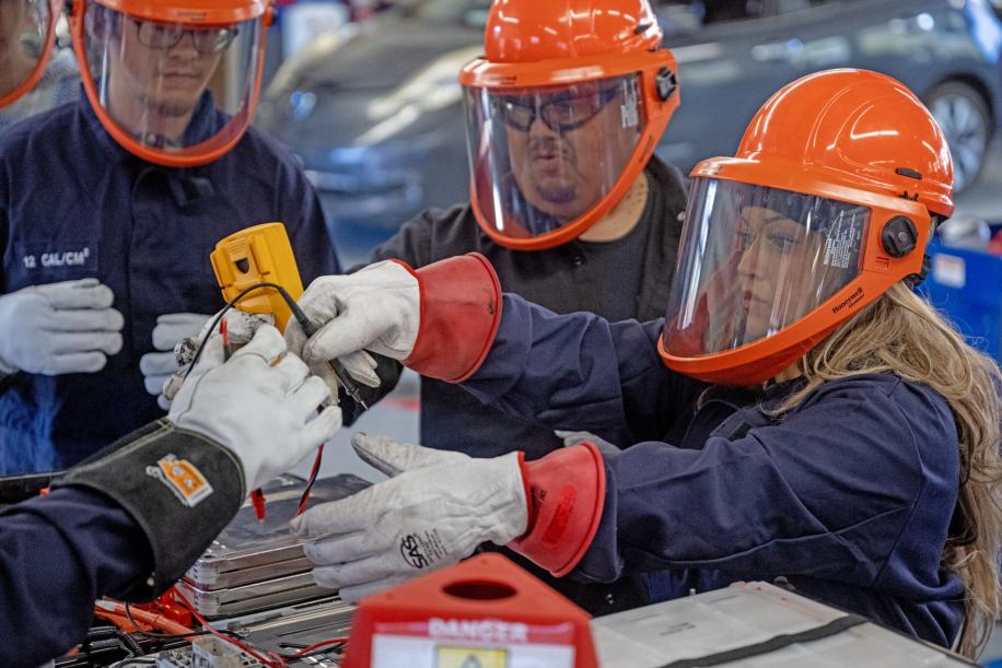 Lucy Amorette, right, tests a battery cell with fellow students, Will Rivas, center, and Christopher Mondragon, far left, at Pueblo Community College Electric Vehicle service class in Pueblo on Thursday, February 19, 2026. (The Gazette, Michael G. Seamans)