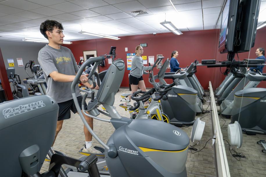 students using the fitness equipment inside the PCC Rec Center