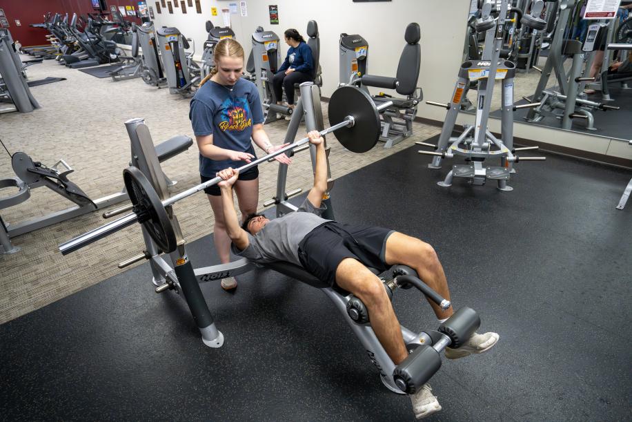 students lifting weights in the PCC Rec Center