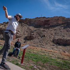 Player throwing disc on the Fremont Campus Disc Golf Course